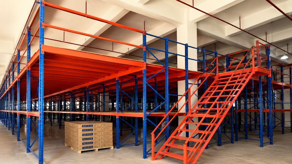 Industrial steel mezzanine floor system with staircase and safety railings for warehouse storage optimization.